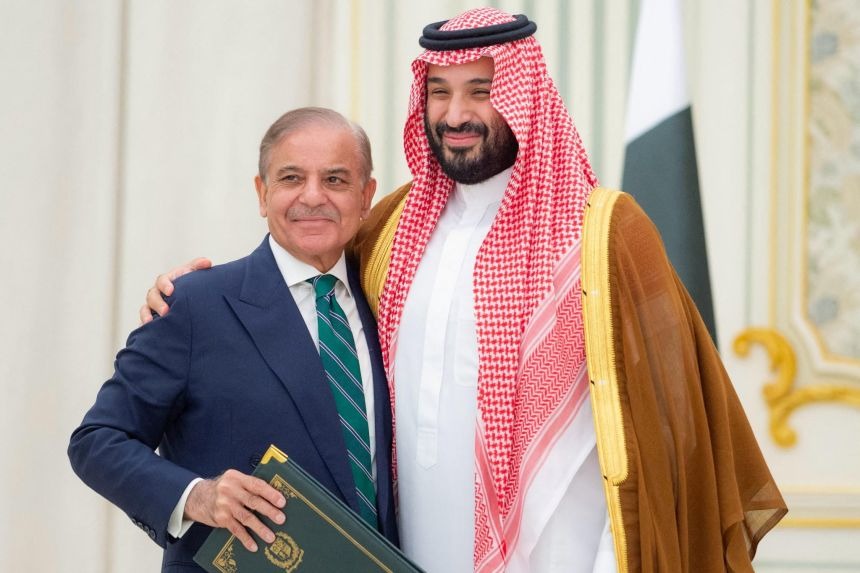 Pakistani Prime Minister Shehbaz Sharif and Saudi Crown Prince Mohammed bin Salman (MBS) embracing after signing a defense pact, symbolizing strong Pakistan-Saudi Arabia relations.